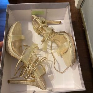 JLO brand strappy heels. they go up to mid calf. only worn once for prom